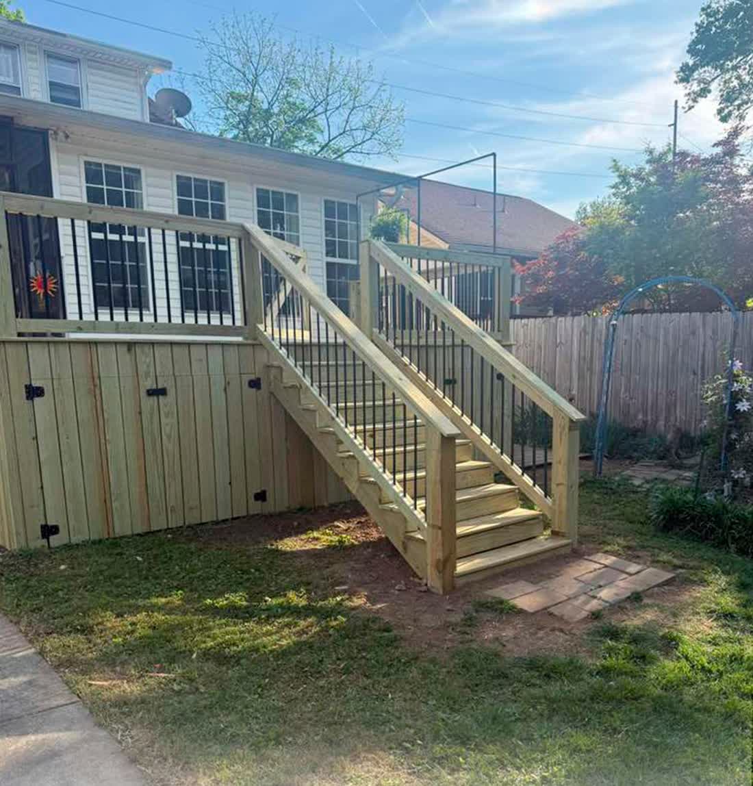 Rebuilt pressure-treated deck with stairs and railings
