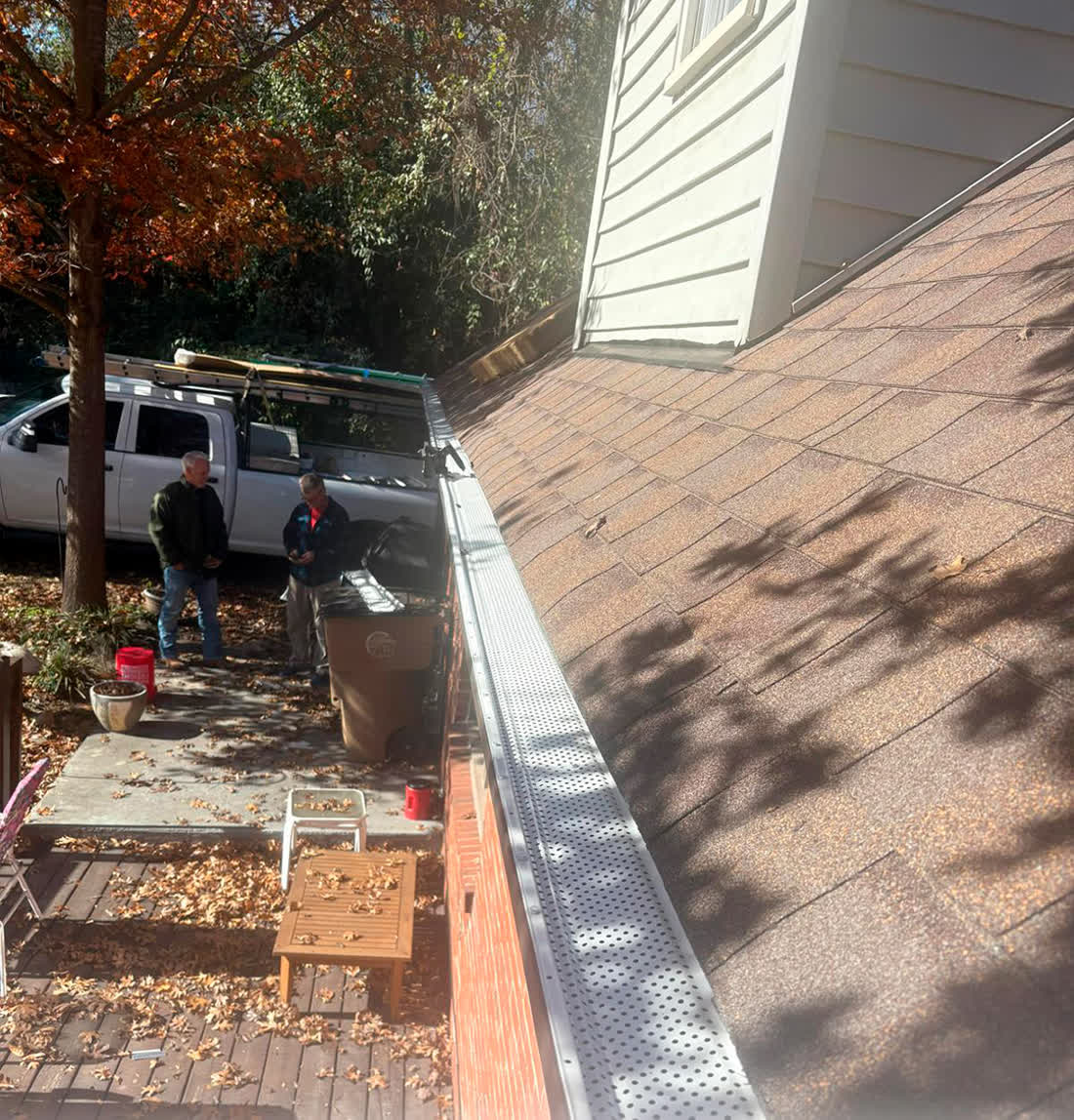 Gutter guards installed along a roof edge