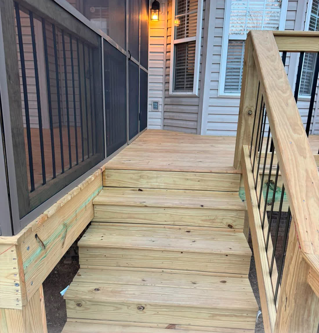 New pressure-treated deck with stairs and metal balusters