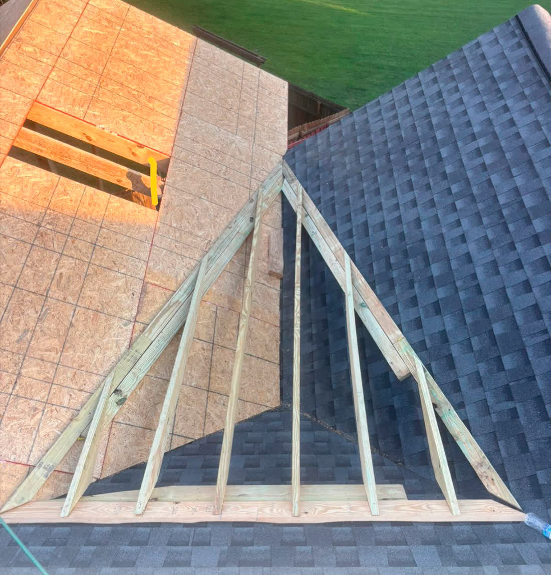 Porch roof rafters framed against the existing roof