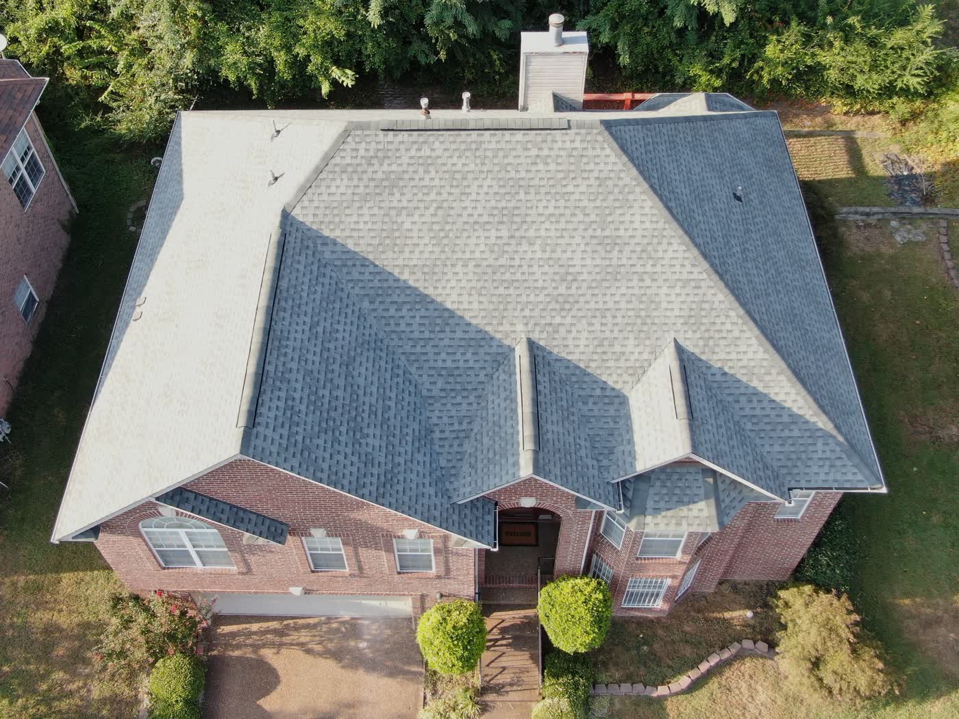 Completed roof on a stone and stucco home