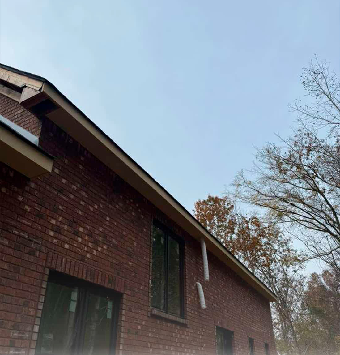 New soffit and fascia installed on a brick home