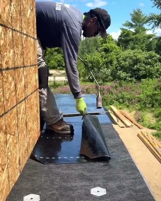 Metal drip edge being formed and set on a roof edge
