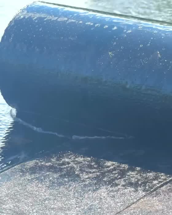Torch-down membrane being heat-welded on a flat roof